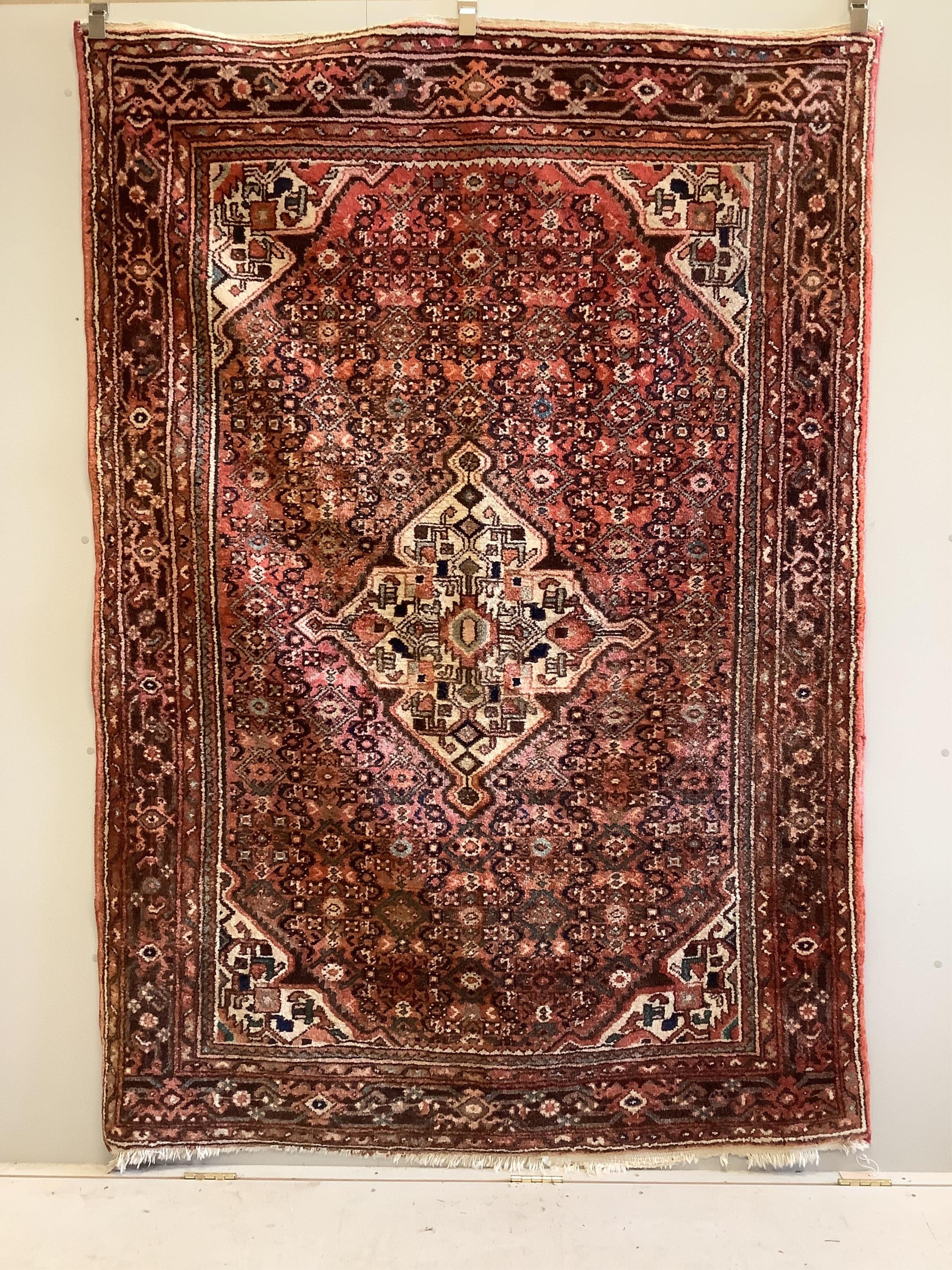 A Hamadan red ground rug, approx. 220 x 160cm. Condition - fair